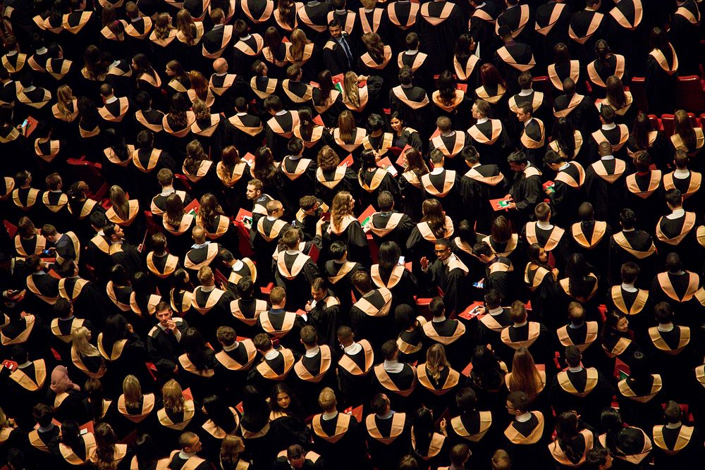 A large crowd of students at a university graduation ceremony. Original public domain image from Wikimedia Commons
