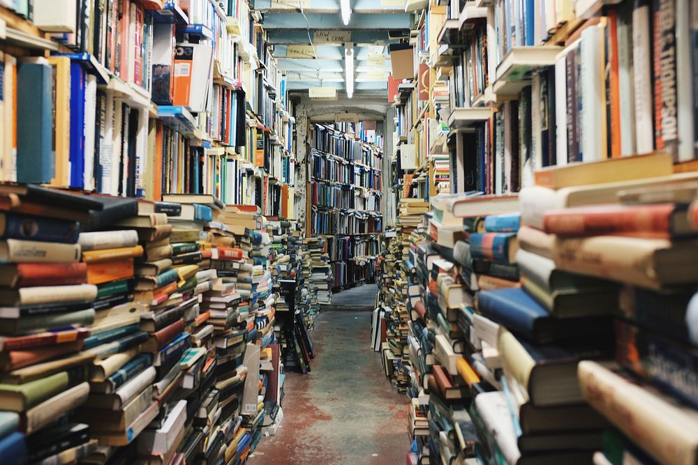 Pathway in the middle of piled books. Original public domain image from Wikimedia Commons