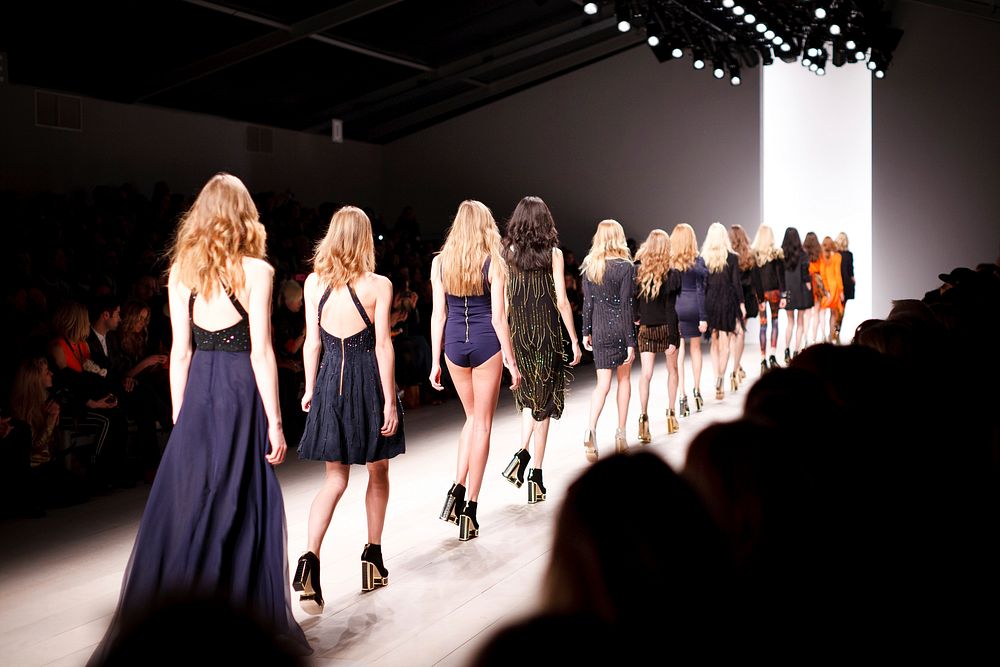 A long line of female models on the catwalk. Original public domain image from Wikimedia Commons