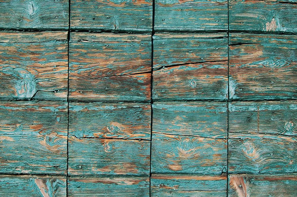 Turquoise paint coming off square wooden planks. Original public domain image from Wikimedia Commons