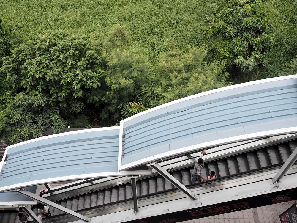 People using solar roof escalator near the forest. Original public domain image from Wikimedia Commons