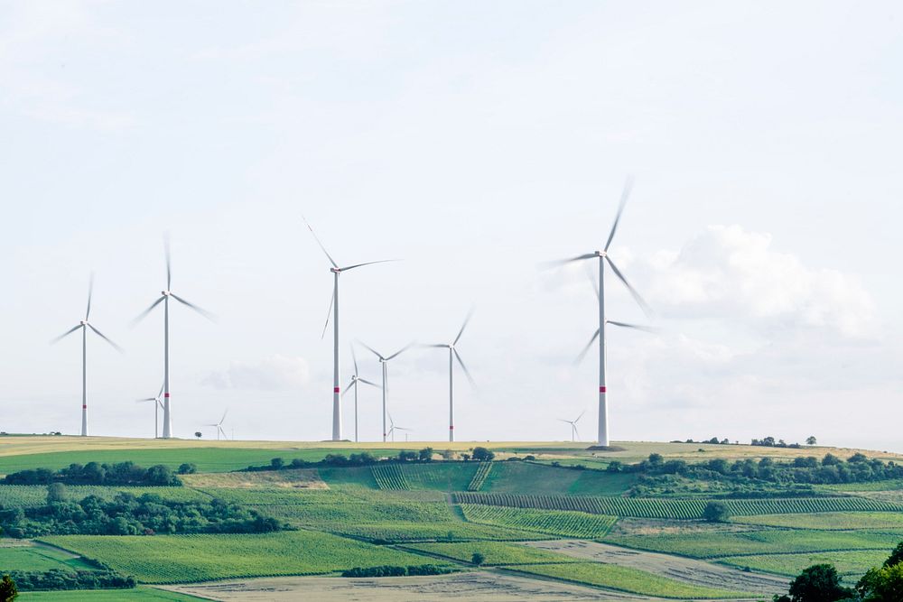 A group of wind turbines in a hilly landscape. Original public domain image from Wikimedia Commons