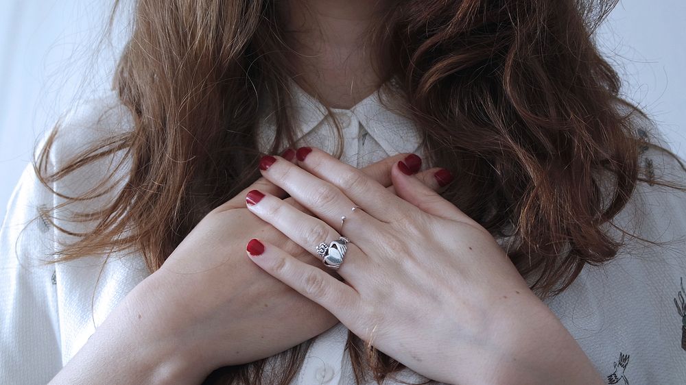 A woman with her hands crossed on her chest. Original public domain image from Wikimedia Commons