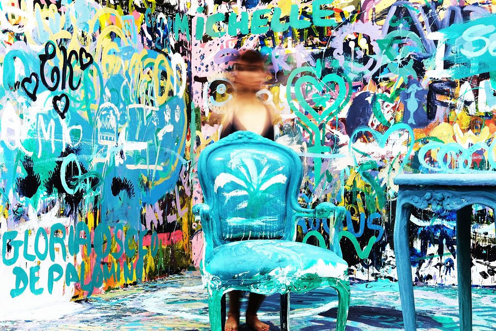 Aqua coloured chair and table in room with wall covered in graffiti, MATE Museo Mario Testino. Original public domain image…