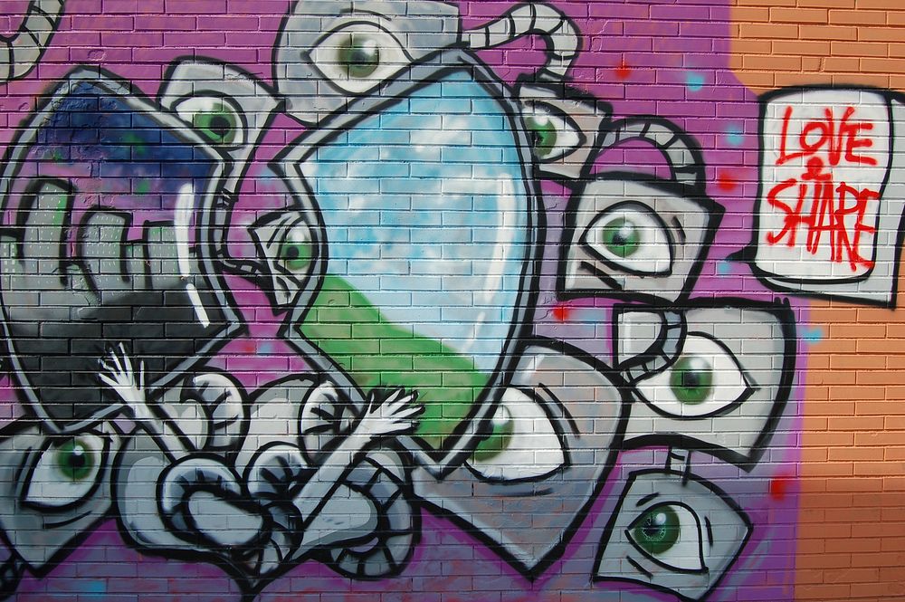 Bright spacey graffiti art on street brick wall, Milan, Italy - 3 June 2016. Original public domain image from Wikimedia…