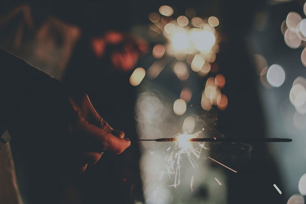 Hand holding sparklers. Original public domain image from Wikimedia Commons