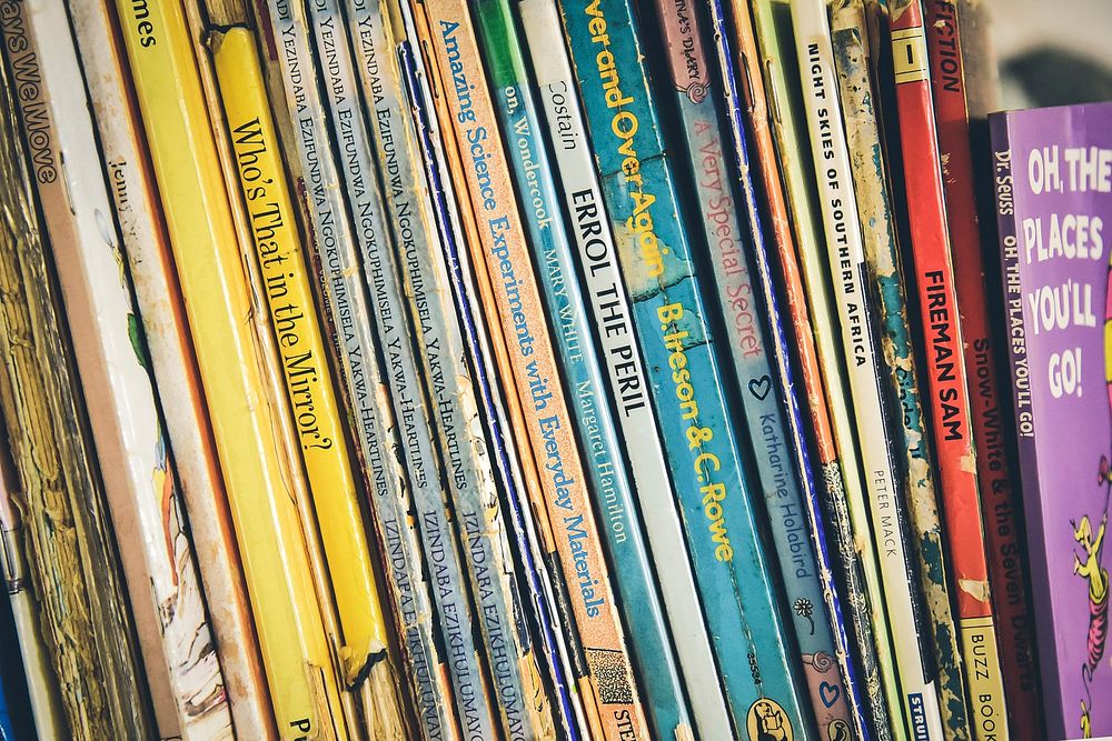 Several children's books on a shelf. Original public domain image from Wikimedia Commons