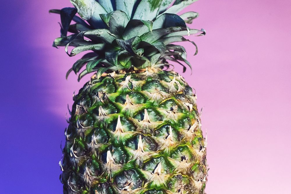 A pineapple against a purple and pink background.. Original public domain image from Wikimedia Commons