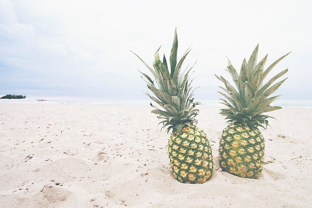 Pineapples side by side on the beach. Original public domain image from Wikimedia Commons