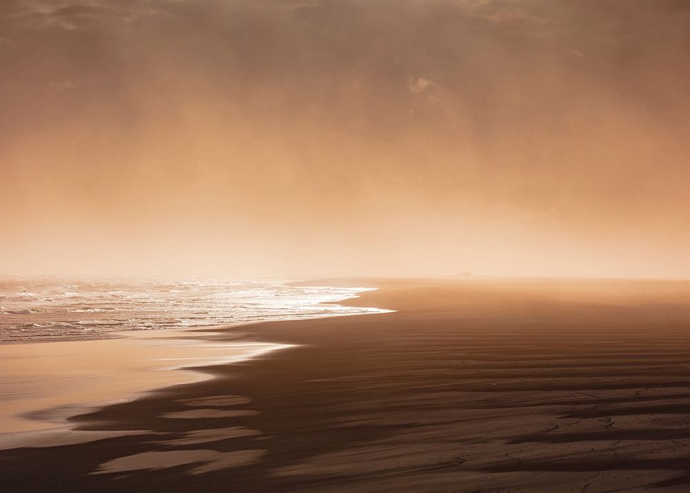 Sunrise through fog from the wet sand beach in Landeyjahöfn. Original public domain image from Wikimedia Commons