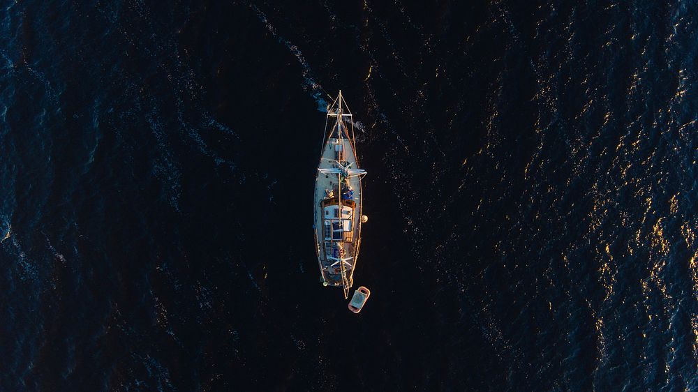 A drone shot of a boat in the ocean. Original public domain image from Wikimedia Commons