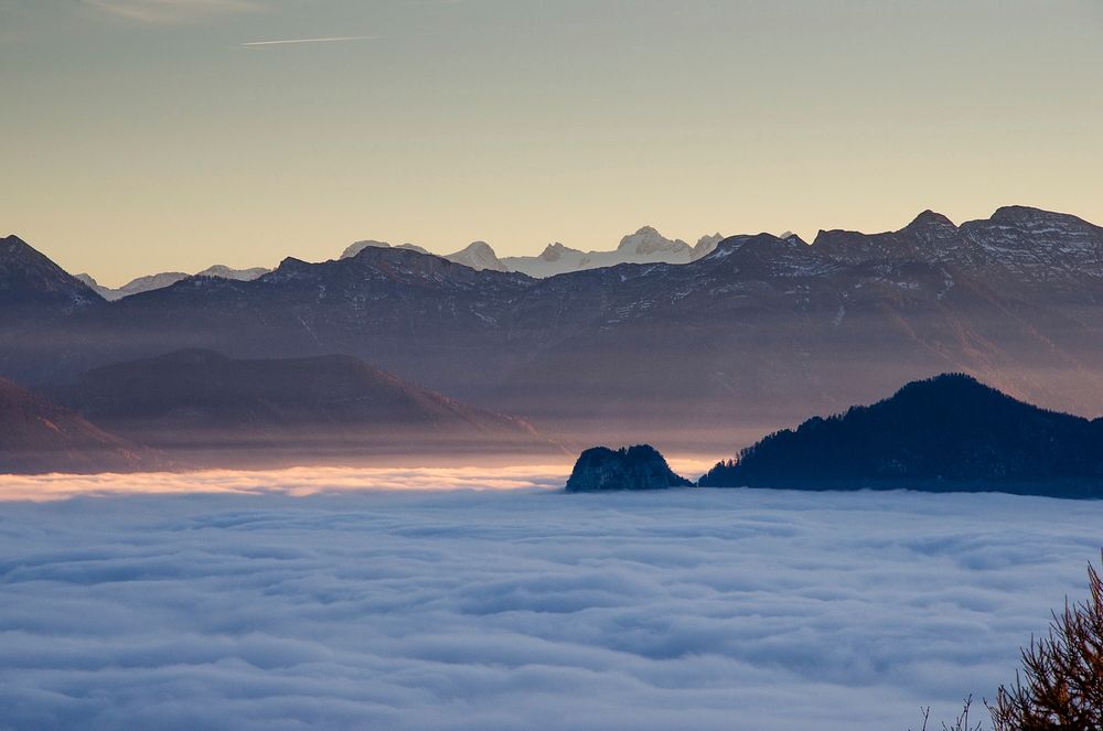 The clouds surrounding the mountains during golden hour in Gmunden. Original public domain image from Wikimedia Commons