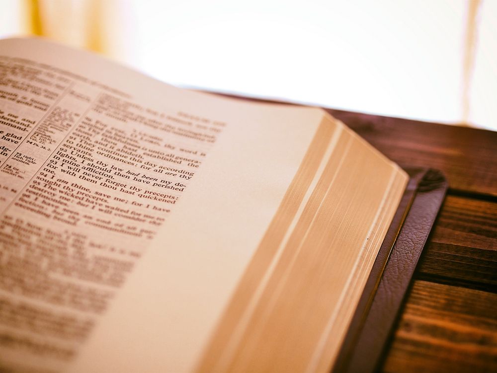 Open bible in a reading room. Original public domain image from Wikimedia Commons