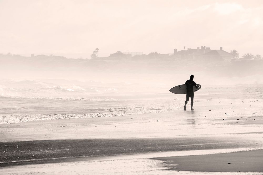 Surfer walking on the beach. Original public domain image from Wikimedia Commons