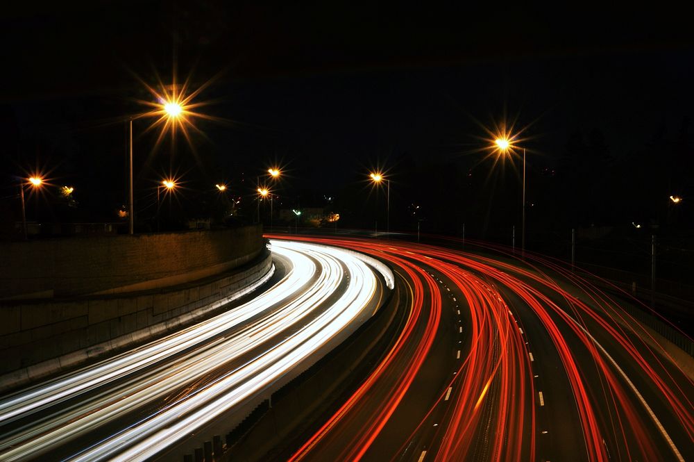 Busy freeway traffic at night. Original public domain image from Wikimedia Commons