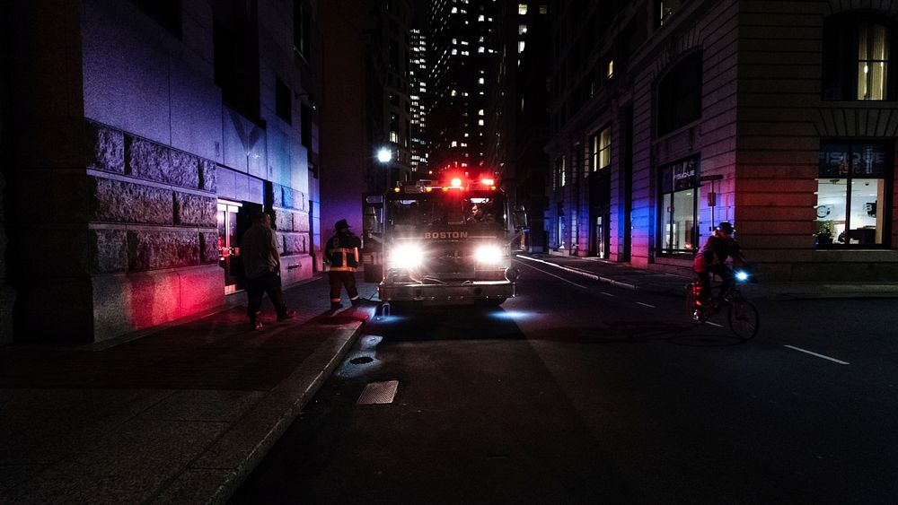Red emergency lights of Boston firefighter truck parked on a street at night. Original public domain image from Wikimedia…