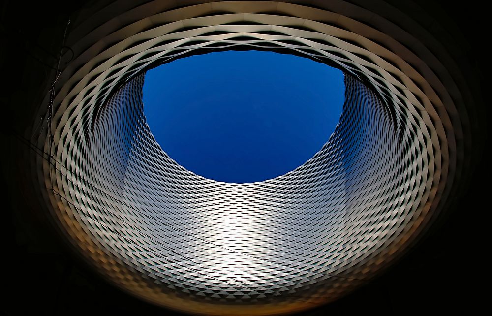 Round modern architectural structure in Messeplatz, Basel, Switzerland. Original public domain image from Wikimedia Commons