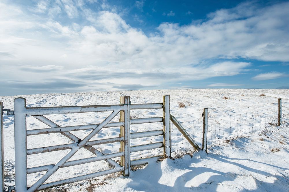 A snow covered fence going across a field in West Yorkshire. Original public domain image from Wikimedia Commons