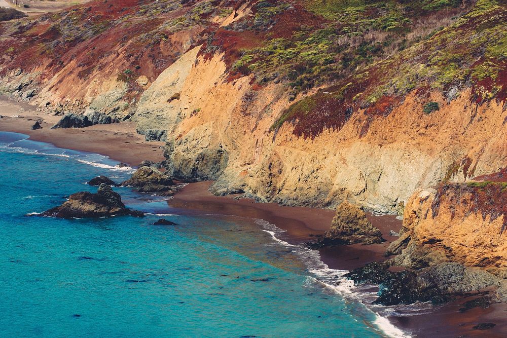 A deserted beach, turquoise sea and rocky cliffs form a surfer's paradise at Marin Headlands. Original public domain image…