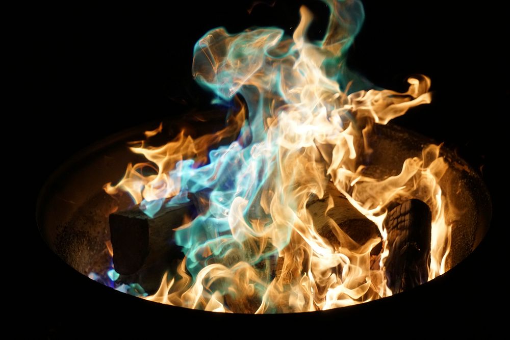 Orange and blue flame on burning wood. Original public domain image from Wikimedia Commons