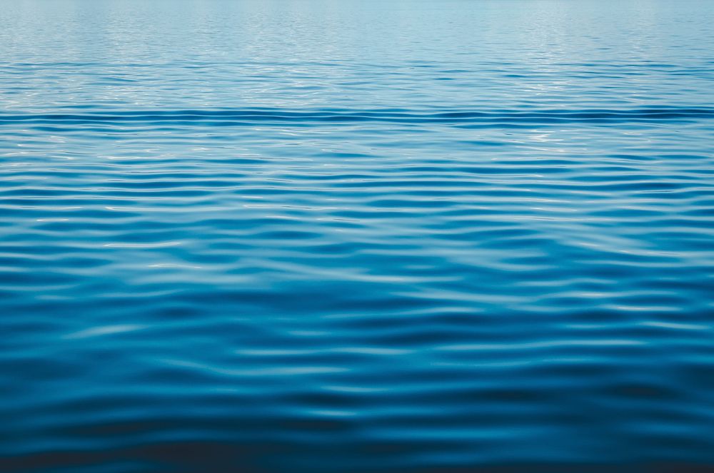 Ripples on the blue surface of a body of water. Original public domain image from Wikimedia Commons
