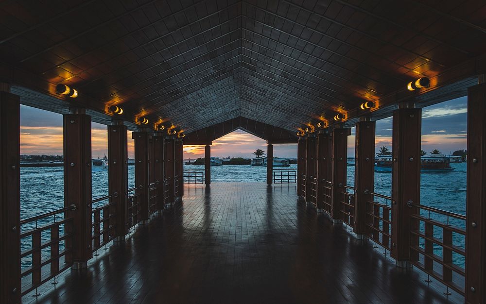 Wooden floor pier with a roof at the sunset. Original public domain image from Wikimedia Commons