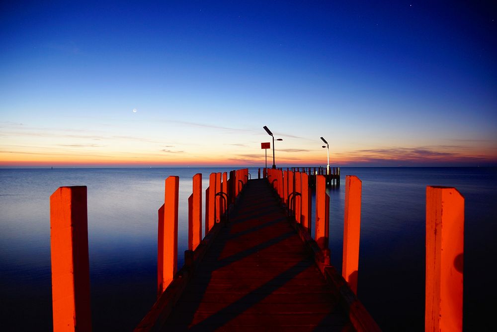 Red dock under clear blue sky. Original public domain image from Wikimedia Commons