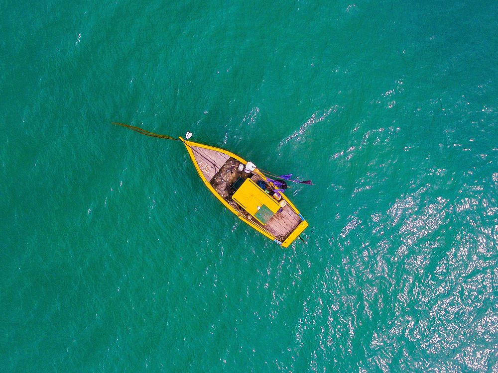 Yellow boat on the ocean.  Original public domain image from Wikimedia Commons