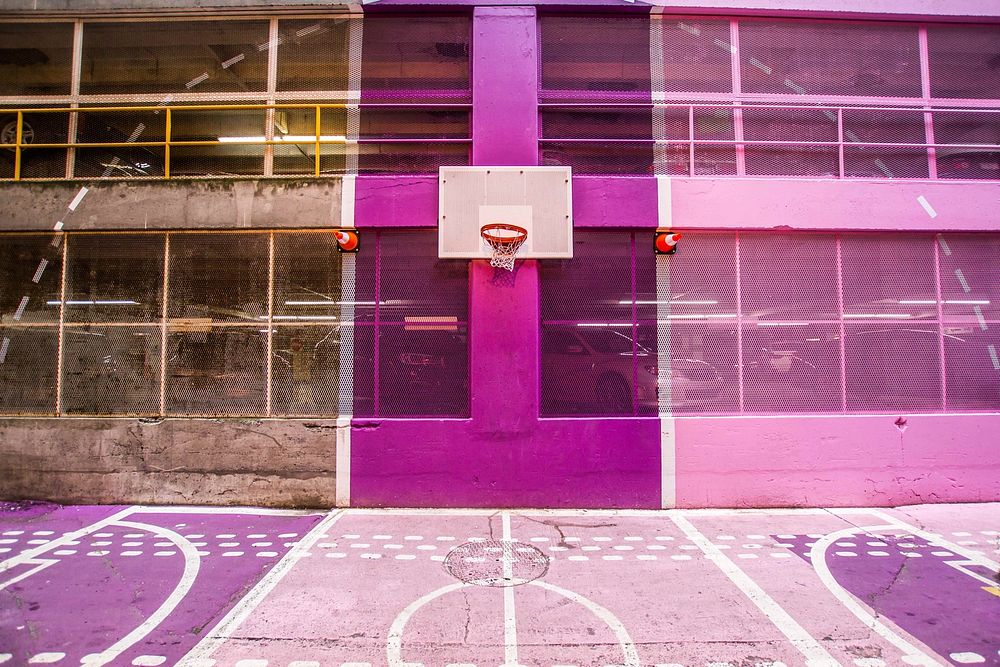 A colorful pink and purple outdoor basketball court. Original public domain image from Wikimedia Commons