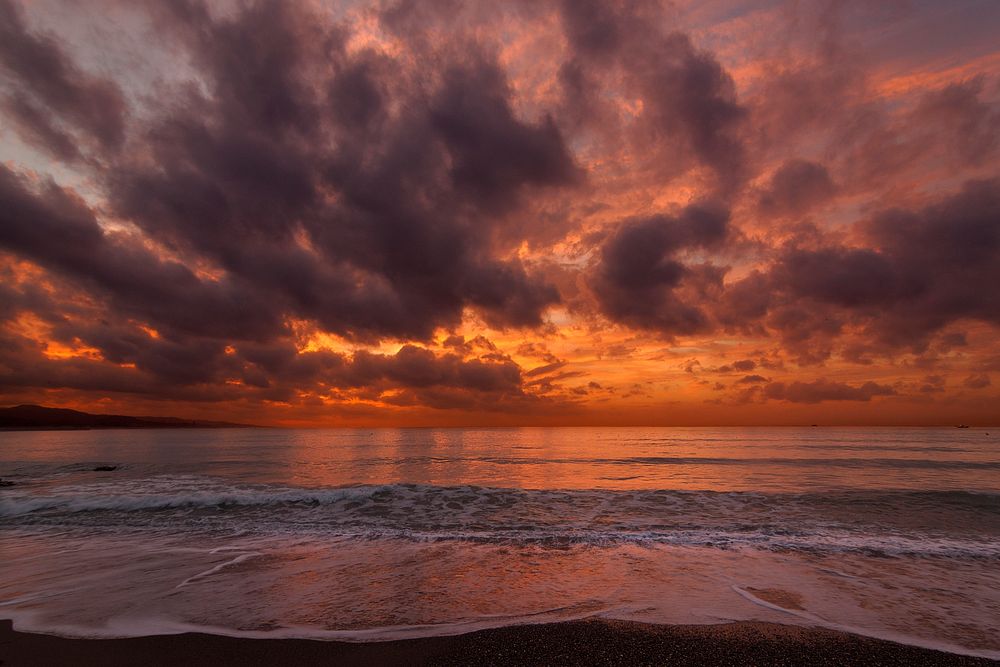 Beach sunset, red sky, cloudy. Original public domain image from Wikimedia Commons