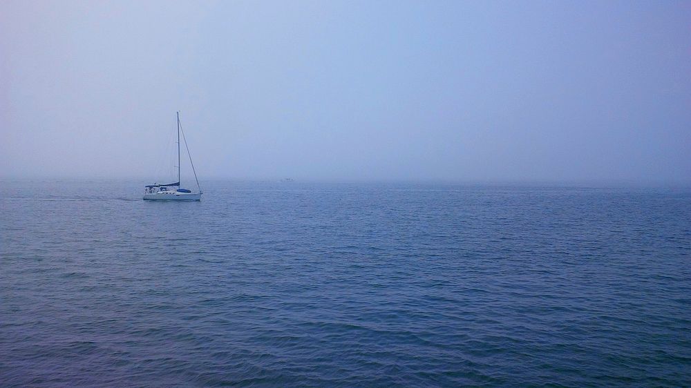 Boat in the middle of the sea. Original public domain image from Wikimedia Commons