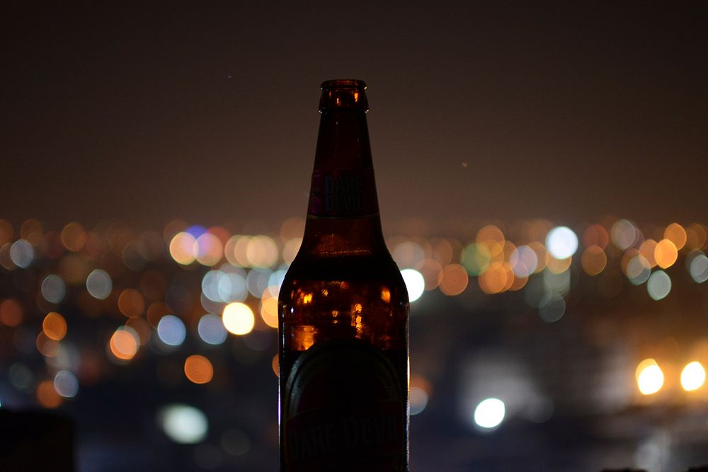 Shallow focus of brown glass bottle. Original public domain image from Wikimedia Commons