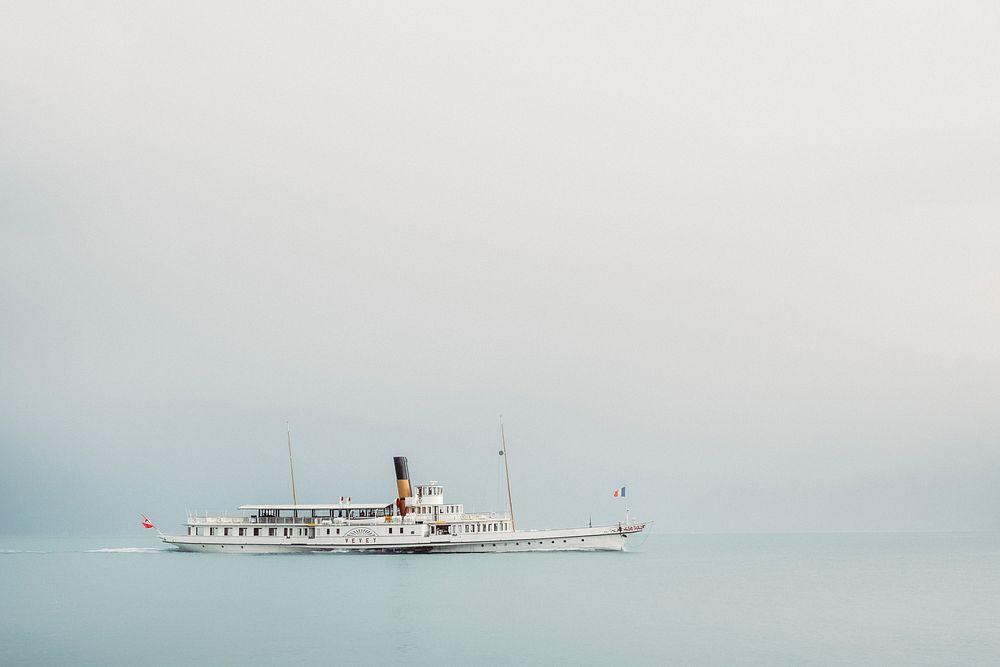 A beautiful steamboat gliding over the calm ocean in Vevey on a foggy day. Original public domain image from Wikimedia…