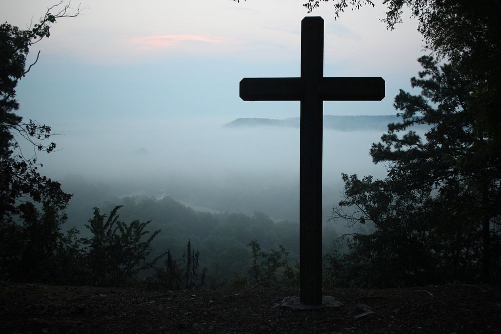 Silhouette of Christian cross near foggy mountain lookout in Egan Camp & Retreat Center. Original public domain image from…