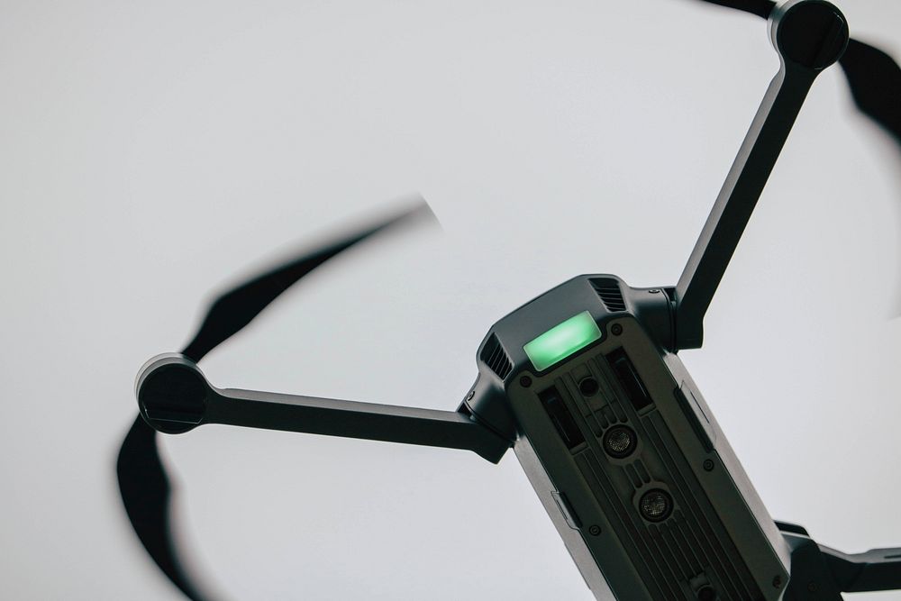 A close-up of a black DJI drone in flight. Original public domain image from Wikimedia Commons