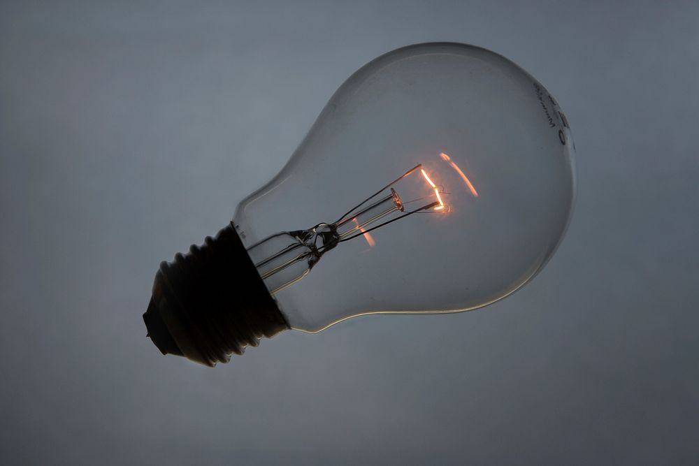 Wireless light bulb with glowing filament inside. Original public domain image from Wikimedia Commons