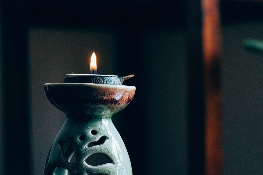 A single candle burning in New Delhi. Original public domain image from Wikimedia Commons