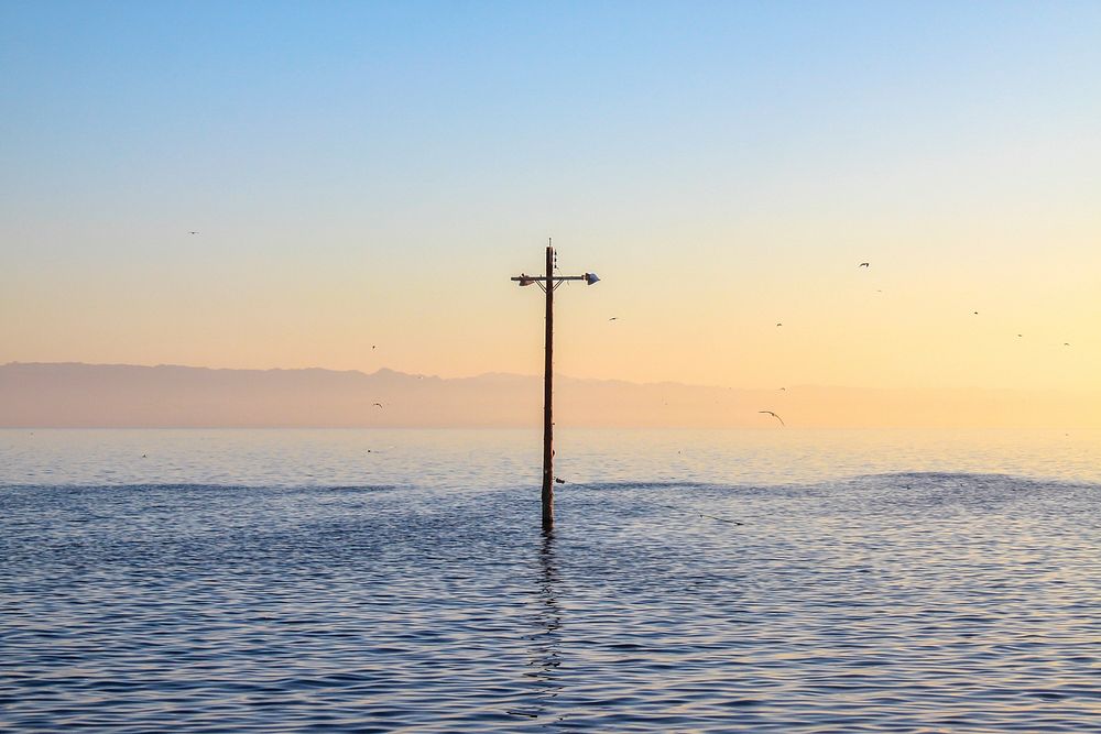 Cross stands in the middle of sea. Original public domain image from Wikimedia Commons