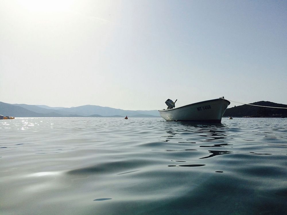 Boat on still water. Original public domain image from Wikimedia Commons