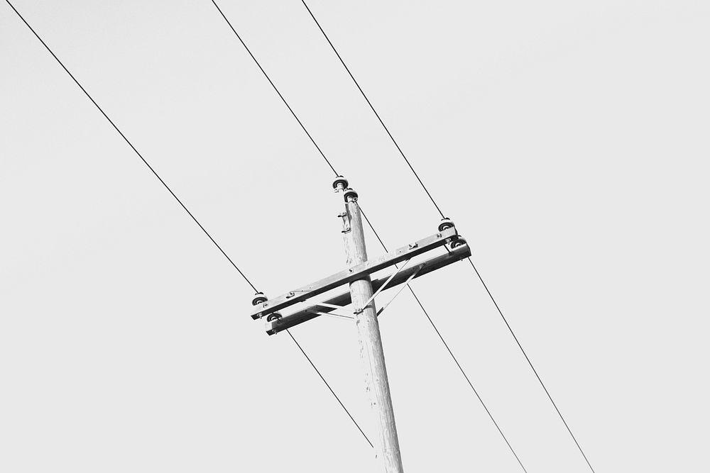 Wooden pole of a minor overhead power line, unidentified location. Original public domain image from Wikimedia Commons