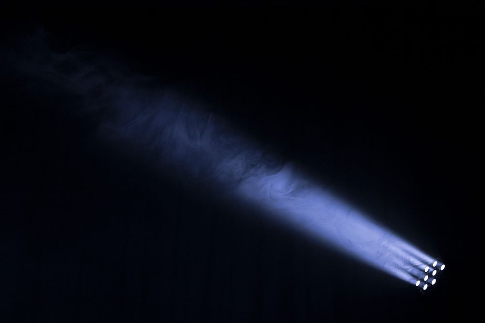 A spotlight shooting a beam into the ark night sky, highlighting smoke in the air in Rossendale, Lancashire, England.…