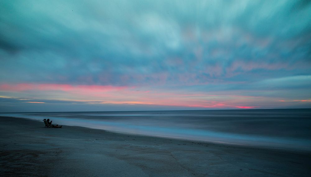 People on the sandy beach after the sunset at Saint Augustine Beach. Original public domain image from Wikimedia Commons