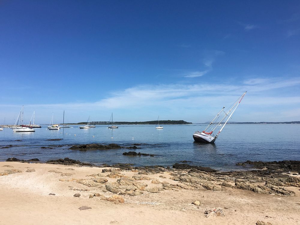 Tilted boat near the harbor by the sand beach at Puerto de Punta del Este. Original public domain image from Wikimedia…