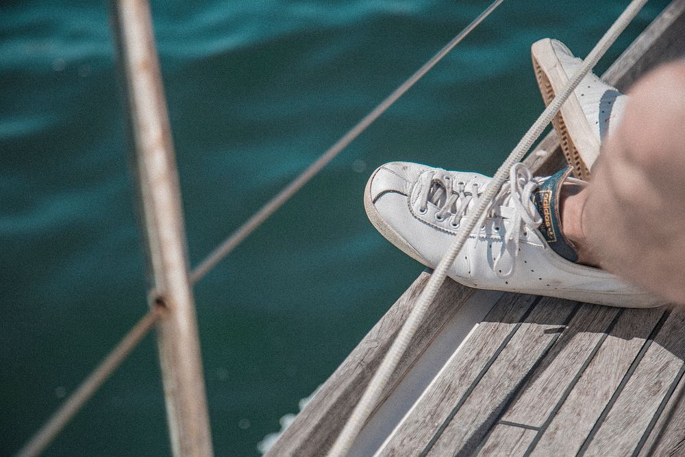 Cropped shot of someone's feet on a boat.deck.. Original public domain image from Wikimedia Commons