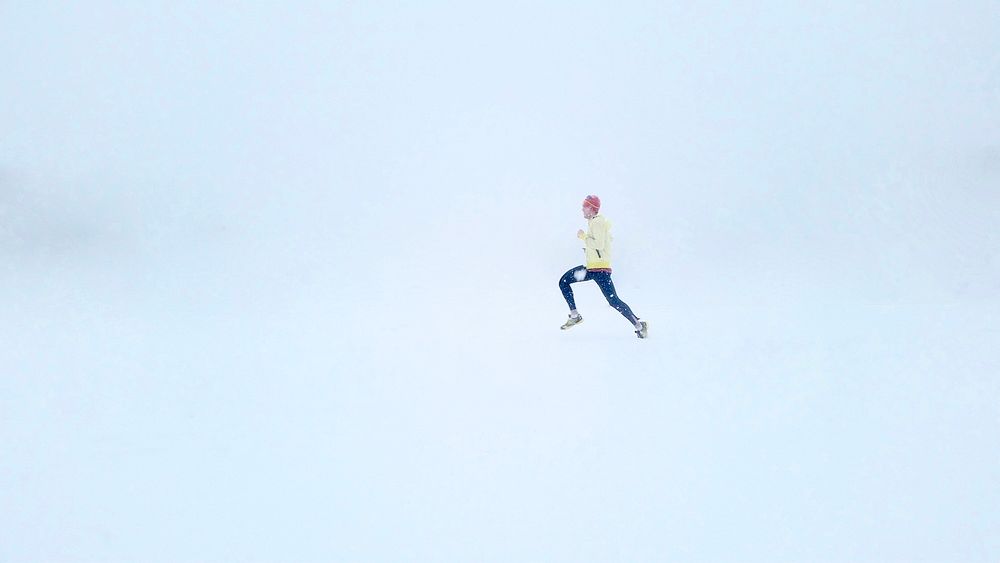 A person running in the snow during a whiteout. Original public domain image from Wikimedia Commons