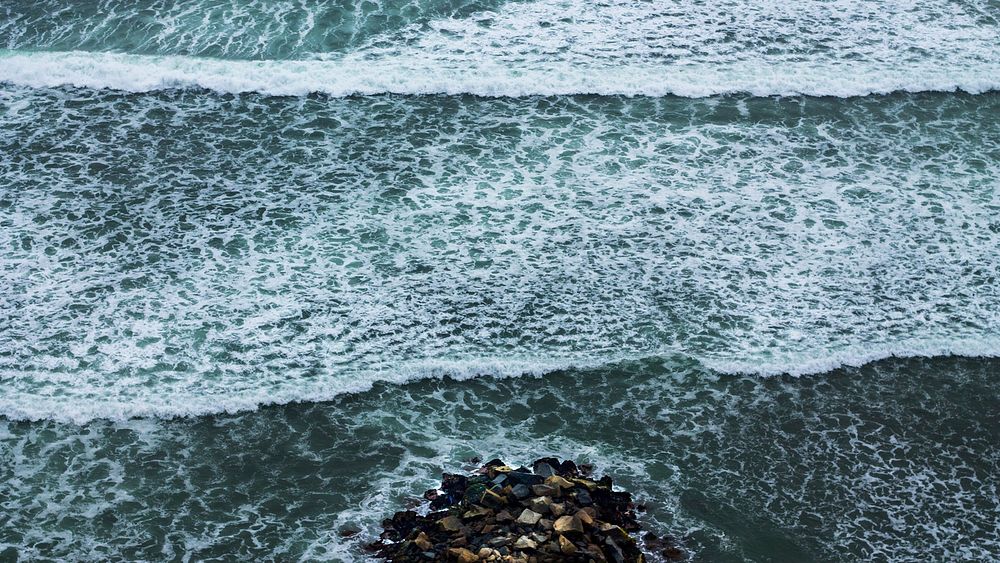 Sea waves with white foam, pebble stones. Original public domain image from Wikimedia Commons