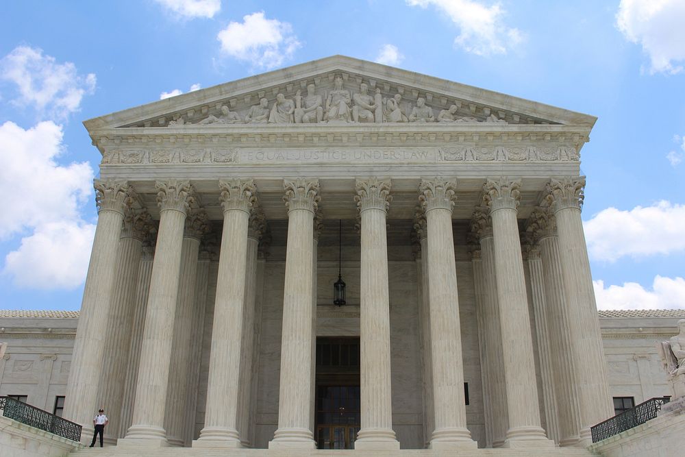 Download Supreme Court Building Behind American Flag Wallpaper