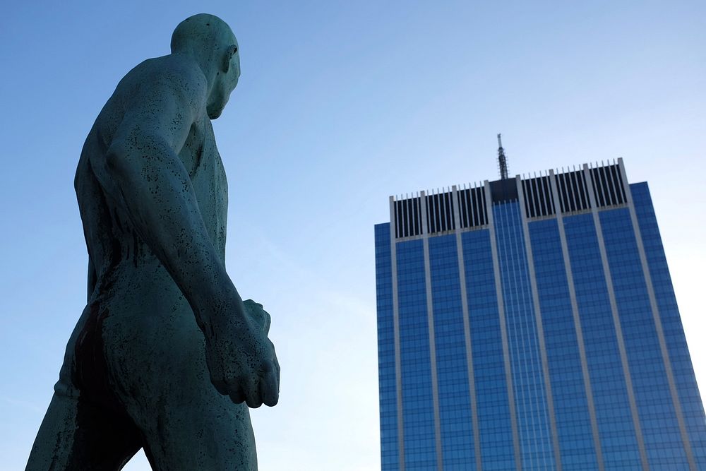 Statue of muscular naked man looking at corporate skyscraper in Bruxelles. Original public domain image from Wikimedia…