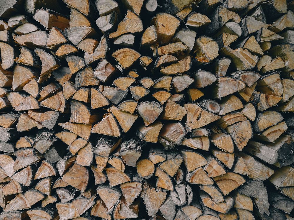 A large stack of firewood cut into wedge-shaped pieces. Original public domain image from Wikimedia Commons