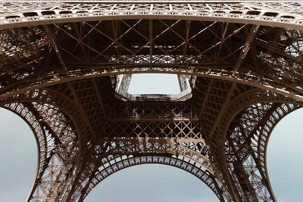 Looking up at the Eiffel Tower from underneath it. Original public domain image from Wikimedia Commons